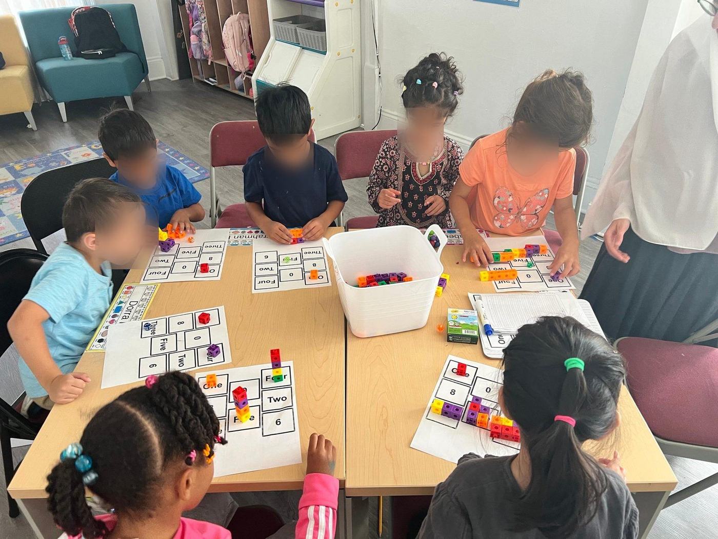 Students playing a hands-on math game with counting cubes