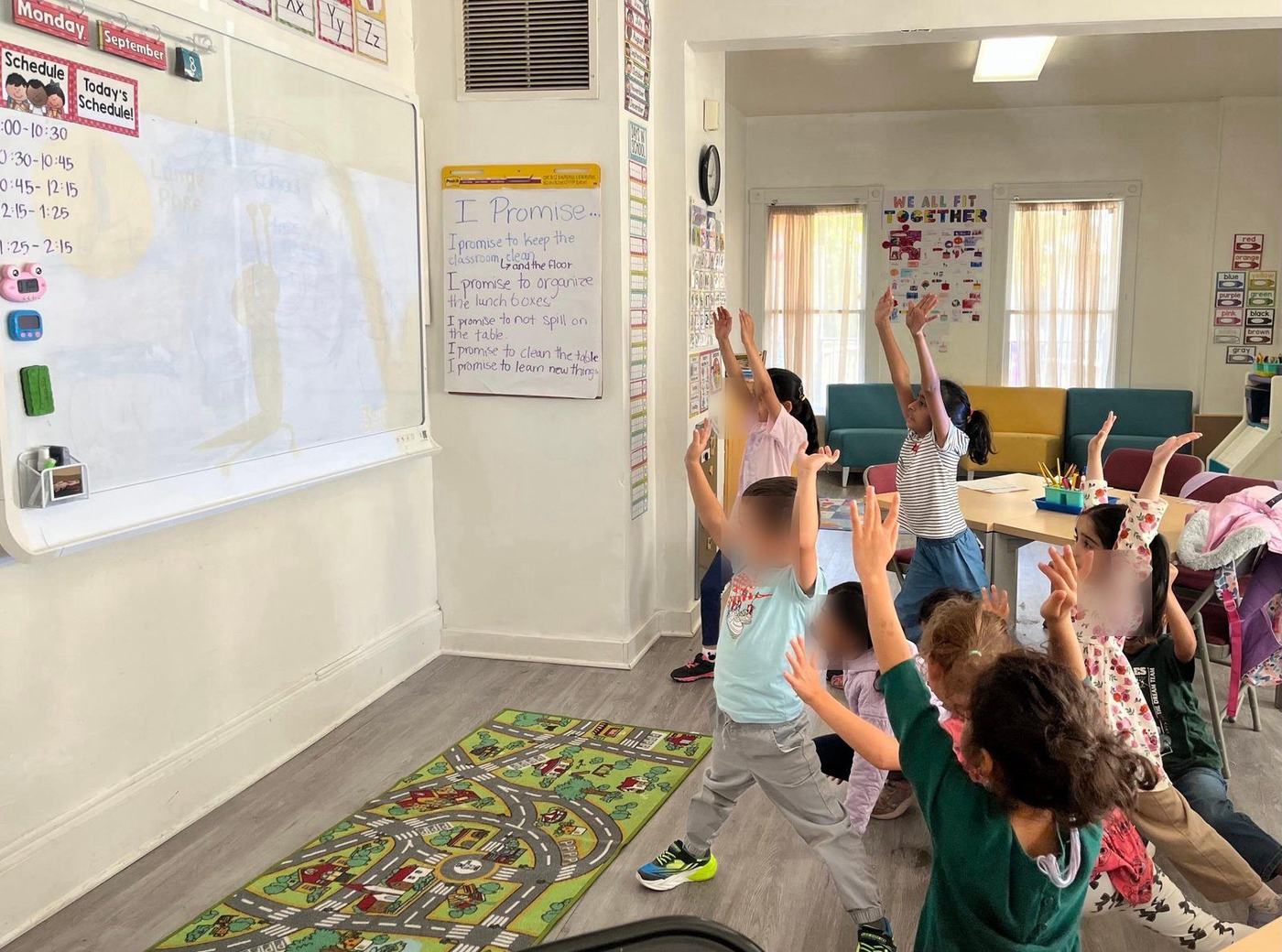 Kindergarteners stretching during a movement break